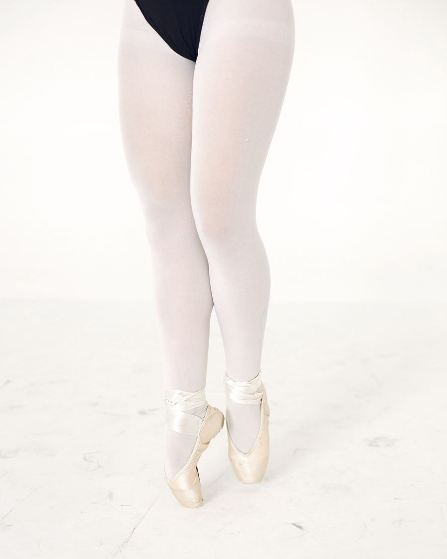 A dancer’s legs in pink ballet tights