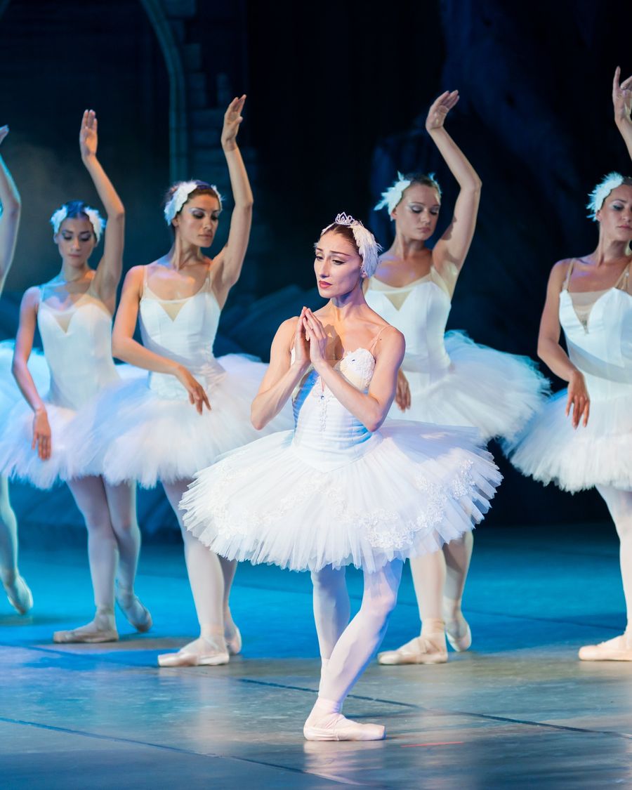 Dancers on stage in classical white tutus